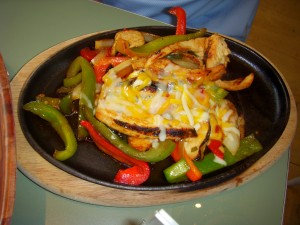 Chicken fajitas with onions, peppers and cheese
