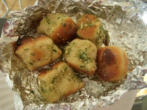 Garlic knots topped with lots of fresh chopped garlic