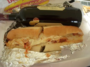 The chicken parm sub is almost as large as a bottle of wine