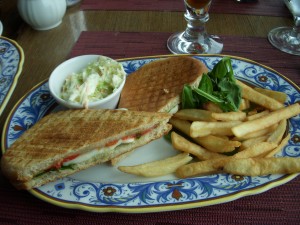Mozzarella, roasted pepper, and basil panini with french fries and cole slaw
