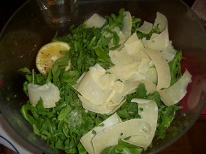 Arugula salad topped with shaved parmesan