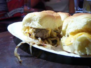 The burgers are topped with american cheese and carmelized onions
