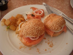 Smoked salmon, cream cheese, onion, tomato, and capers on rolls with breakfast potatoes