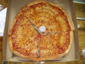 A slight disheveled pizza