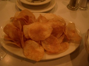 Freshly fried thin and crispy potato chips