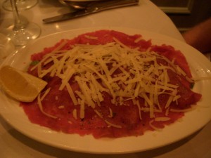 Beef carpaccio served over arugula
