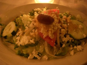 Salad topped with pieces of crumbled feta