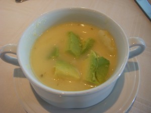 Broccoli and cheese soup topped with fresh avocado