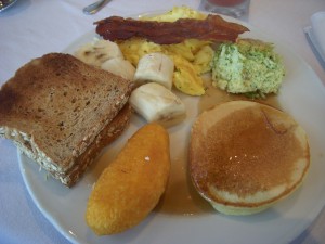 Whole wheat toast, bananas, scrambled eggs, bacon, broccoli frittata, pancake, fried yuca filled with cheese