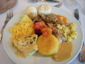 Rice, avocado, pan de yuca, suckling pig, hominy, yuca fritter, fish I think, beet salad in the middle