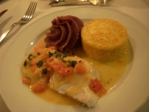 Some kind of white fish topped with bruschetta