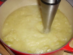 Blending the soup with the immersion blender