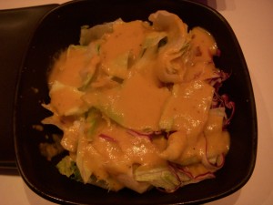 Crisp, fresh garden salad with ginger dressing served in a chilled bowl