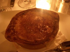French onion soup covered in a thick layer of gruyere