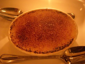 Creme brulee with an evenly browned sugary crust but a too warm and liquidy interior