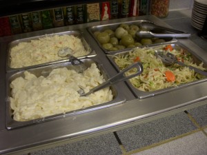 Potato salad, cole slaw, health salad, and pickled green tomatoes