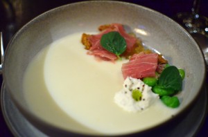 Spring garlic veloute with fava beans, ricotta, and ham
