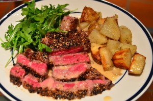 Steak au poivre with foie gras fat roasted potatoes and arugula salad