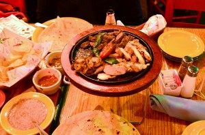 Chicken and steak fajitas with various accompaniments